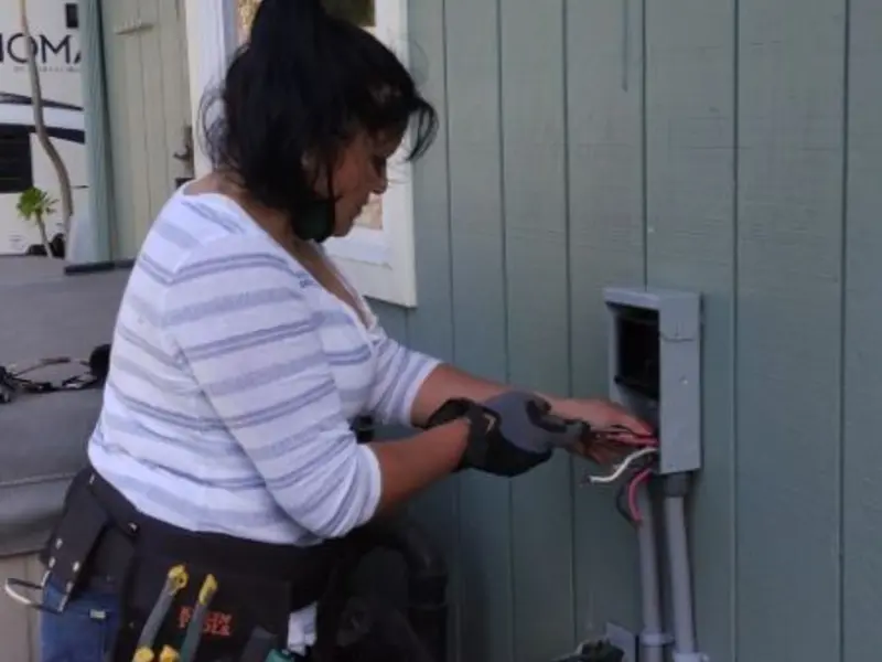 Licensed electrician wiring an exterior subpanel in Reedsport
